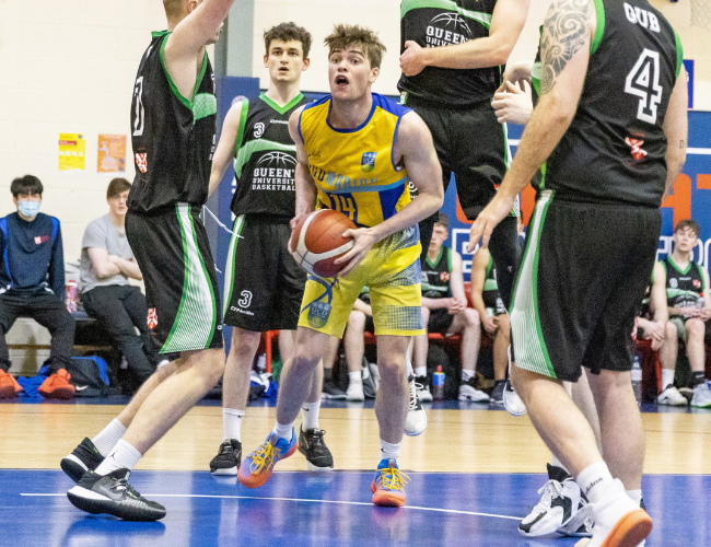 UCD Marian player playing basketball